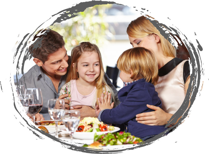 Family at a table eating plates of food